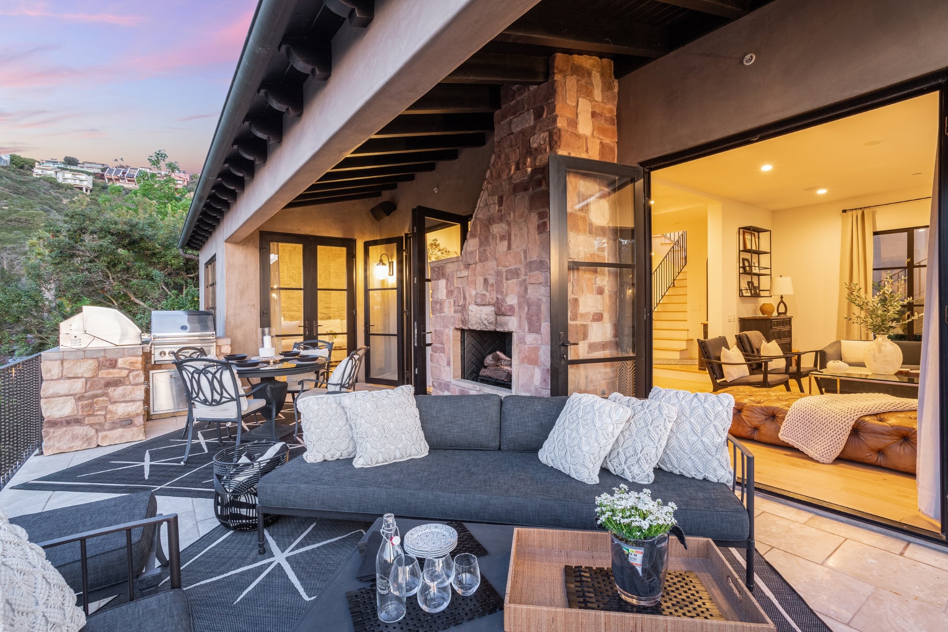 Outdoor stone fireplace and lounge at sunset
