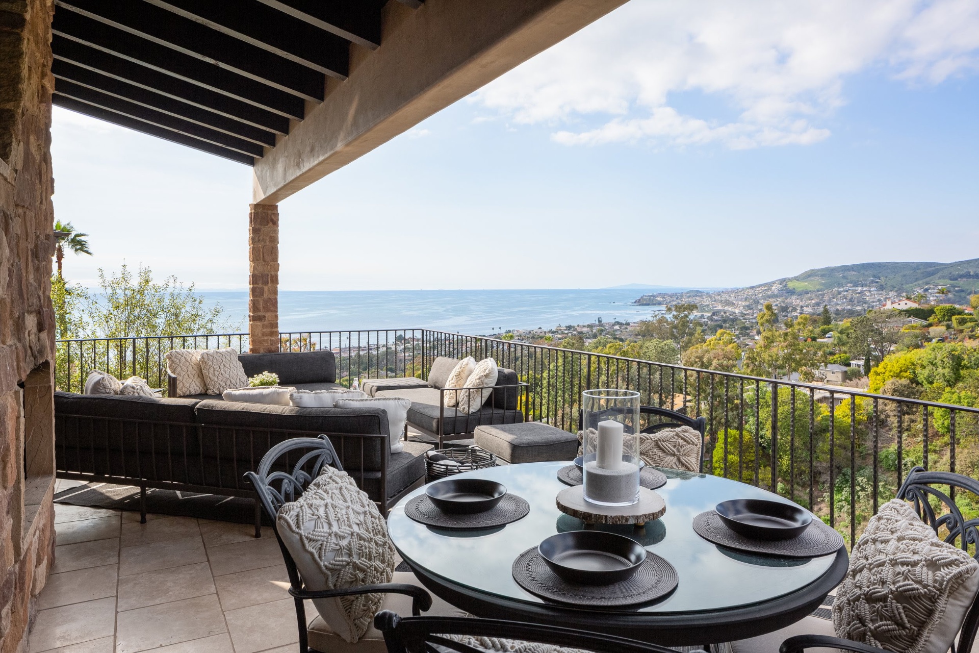 Covered terrace with ocean and hillside views